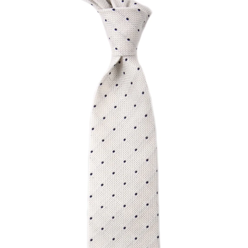 White grenadine silk tie with navy blue polka dots