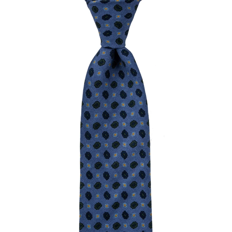 Blue wool tie with a small pattern in green and navy blue