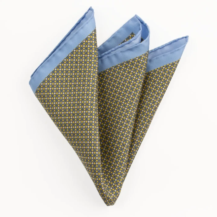 Printed silk pocket square with a fine geometric pattern - yellow and blue, folded into a point