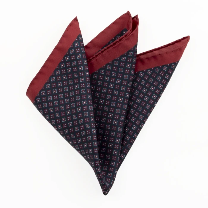 Printed silk pocket square with a fine geometric pattern - navy and burgundy, folded into a point