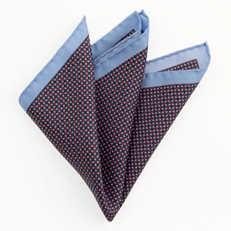 Printed silk pocket square with a fine geometric pattern - navy and blue, folded into a point