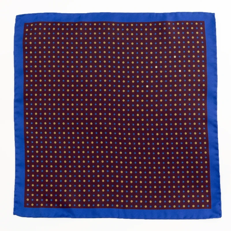 Burgundy silk pocket square with small flowers and blue border, flat view