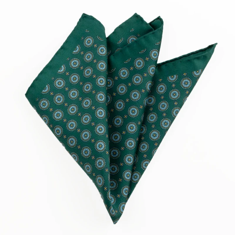 Printed silk pocket square with medallions - bottle green, light blue and gold, folded into a point
