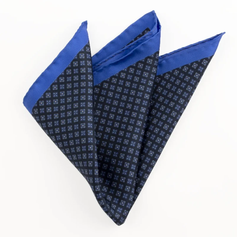 Printed silk pocket square with a fine geometric pattern - navy and blue, folded into a point