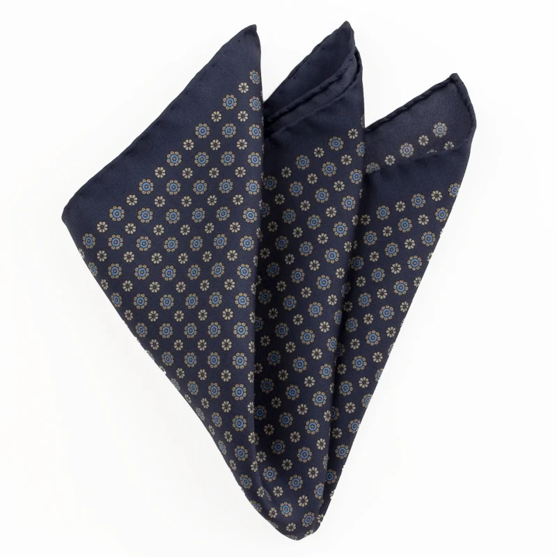 Printed silk pocket square with small rosettes - navy, blue and gold, folded into a point