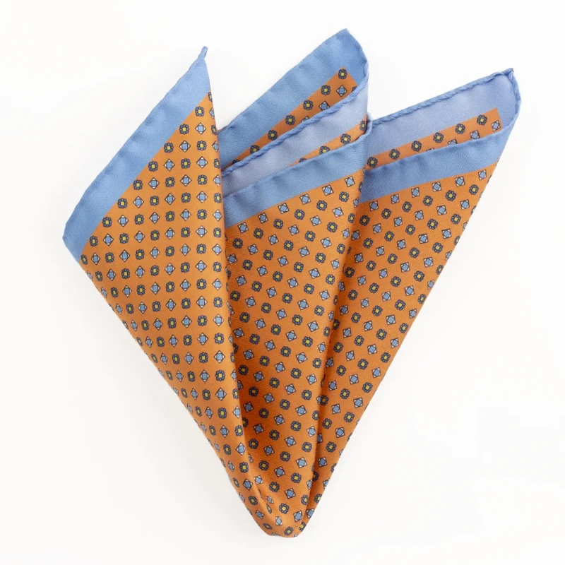 Printed silk pocket square with a fine geometric pattern - orange and blue, folded into a point