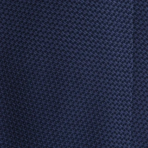 A close-up of a navy blue silk jacquard tie with a fine weave