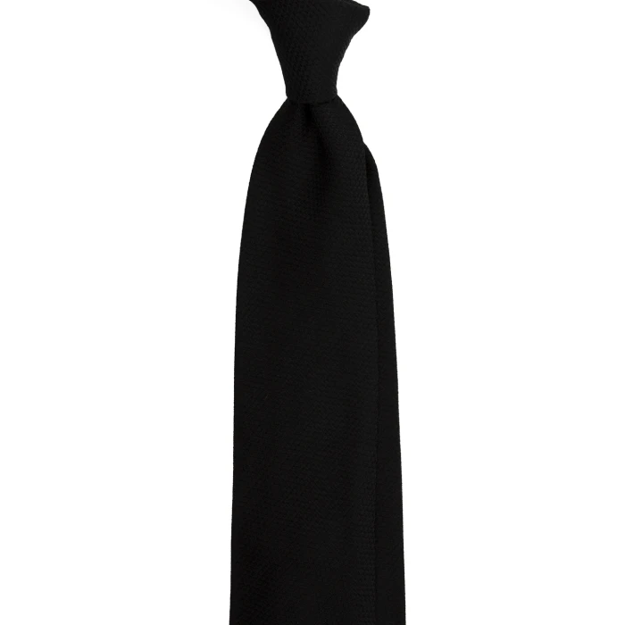 A black silk jacquard tie with a fine weave, tied in a knot