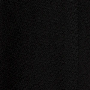 A close-up of a black silk jacquard tie with a fine weave
