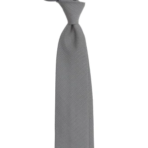 A black and white silk jacquard tie in fine houndstooth, tied in a knot