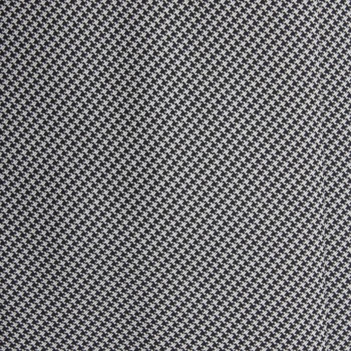 A close-up of a black and white silk jacquard tie in fine houndstooth