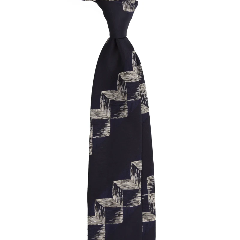 A navy silk jacquard tie with a geometric pattern, tied in a knot