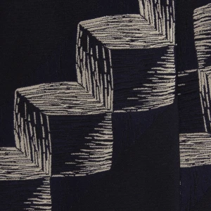 A close-up of a navy silk jacquard tie with a geometric pattern