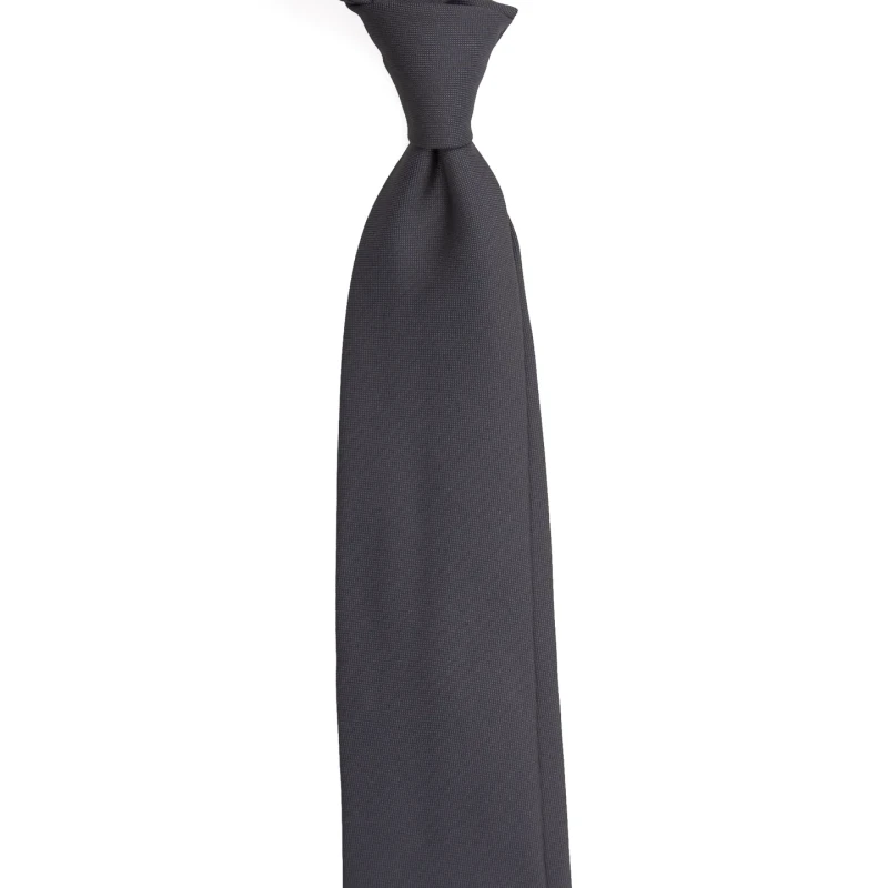 A charcoal silk jacquard tie with a fine texture, tied in a knot
