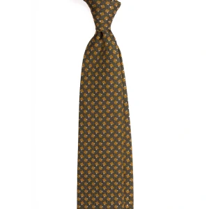 An olive silk jacquard tie with a small geometric pattern, tied in a knot