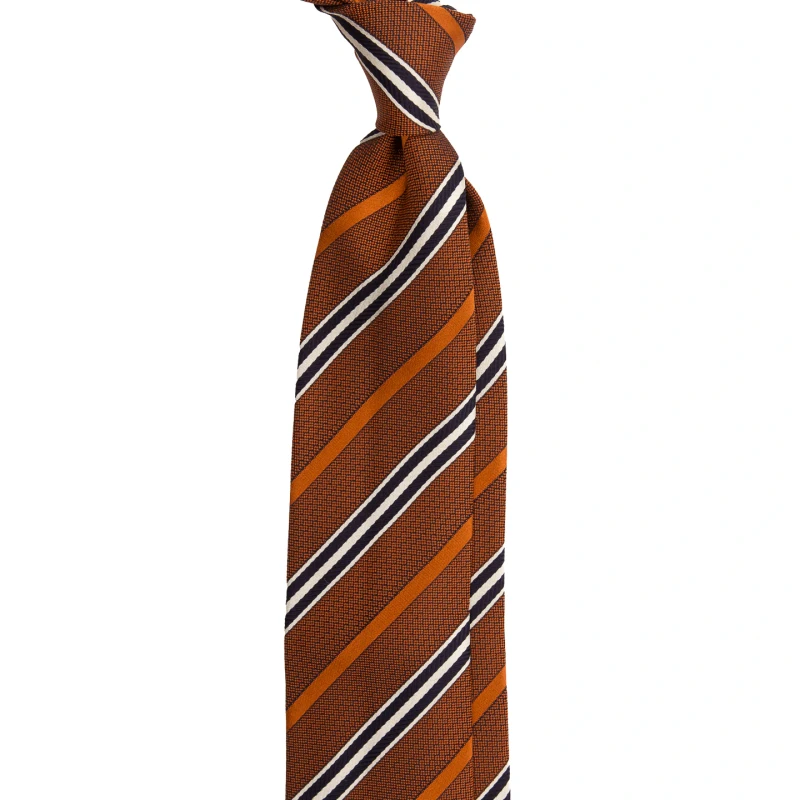 A orange silk jacquard tie with navy and cream pinstripes, tied in a knot