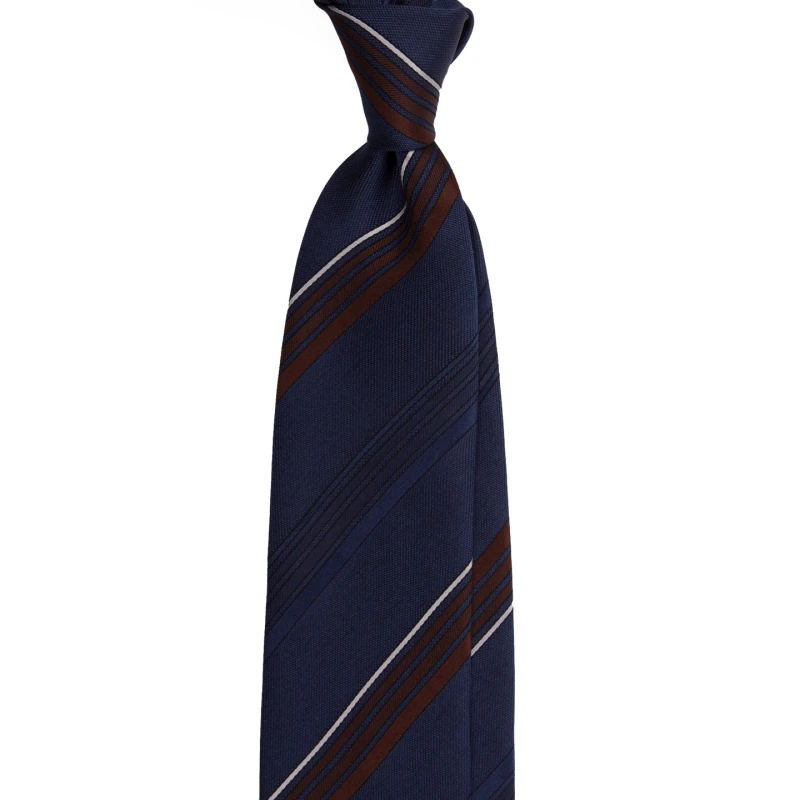 A navy silk jacquard tie with brown and grey pinstripes, tied in a knot