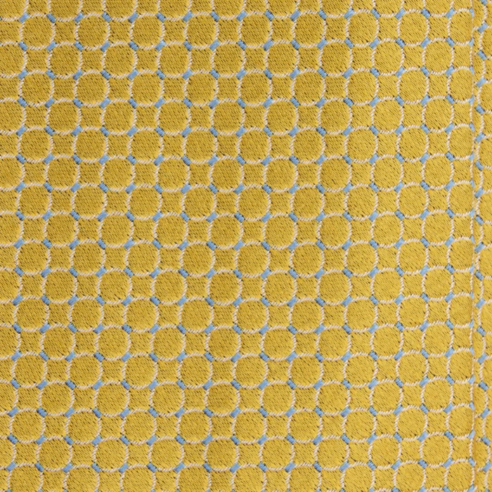 A close-up of a yellow silk jacquard tie with a circle pattern and blue accents