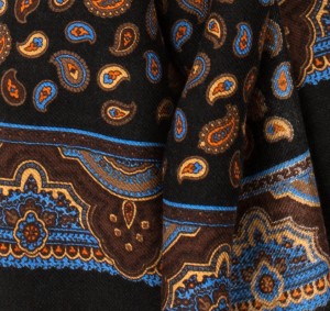 Black scarf with a fine paisley pattern in shades of brown, blue, yellow, and orange - fabric's texture