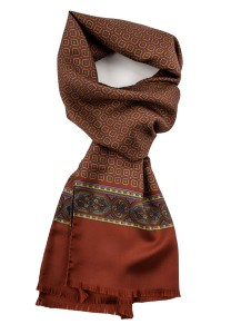 Rusty silk scarf with geometric yellow and blue flowers finished with an ornamental stripe and fringes