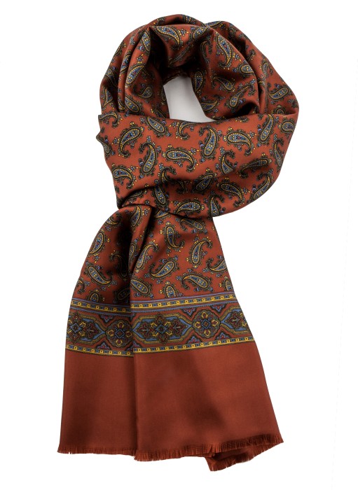 Rusty silk scarf in fine paisley in blue, yellow and green, finished with an ornamental stripe and fringes