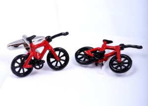 Red cufflinks in the shape of bicycles