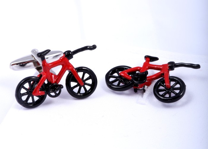Red cufflinks in the shape of bicycles